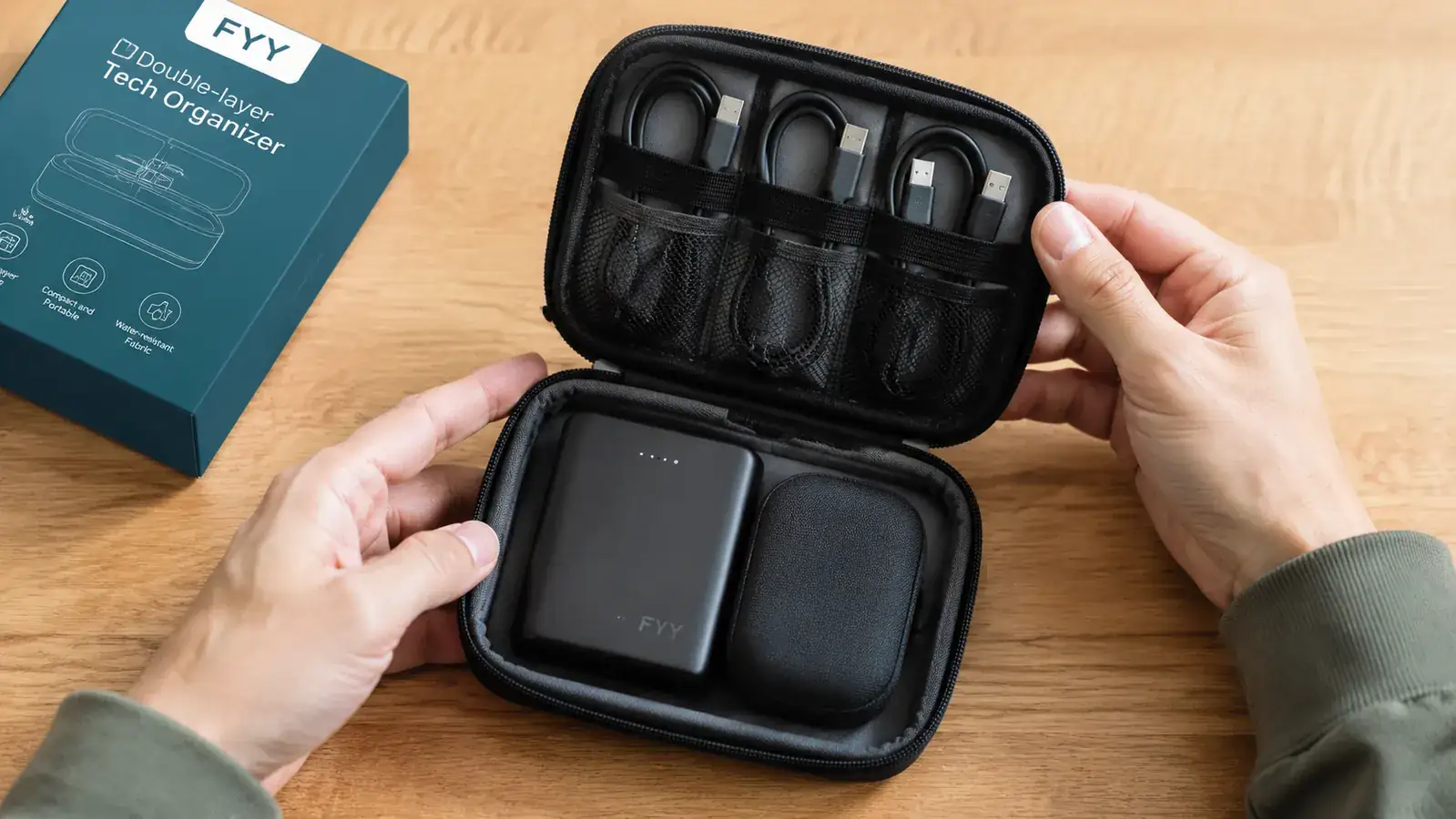 Cable organizer pouch open showing double-layer layout with USB-C cable, earbuds, adapter, and power bank