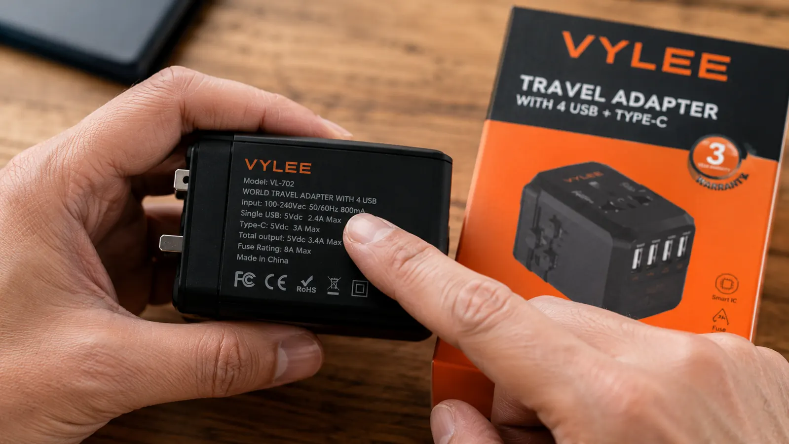 Close-up of a dual-voltage label on a laptop power brick reading 100-240V 50-60Hz